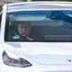 Tesla CEO Elon Musk uses his mobile device as he sits in the car arriving to the construction site for the new plant, the so-called “Giga Factory”, of US electric carmaker Tesla in Gruenheide near Berlin, northeastern Germany. - The site still has only provisional construction permits, but Tesla has been authorized by local officials to begin work at its own risk. Tesla is aiming to produce 500,000 electric vehicles a year at the plant, which will also be home to “the largest battery factory in the world”, according to group boss Elon Musk. (Photo by Odd ANDERSEN)